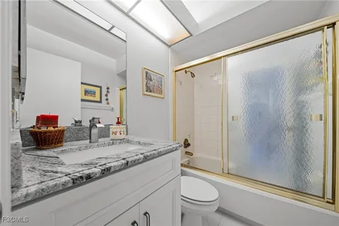 a room with furniture a chandelier and a window