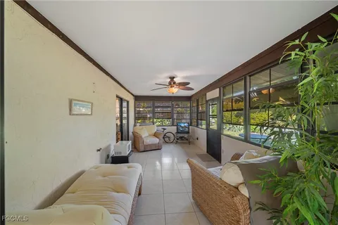 a view of a patio with table and chairs and potted plants