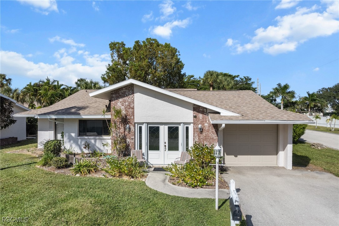 11650 Pointe Circle Fort Myers, FL 33908 - Photo 21 of 40 a front view of house with a garden and patio