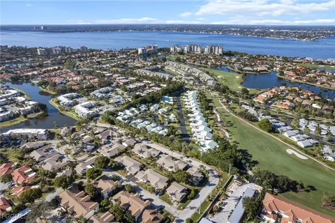 an aerial view of lake and residential houses with outdoor space