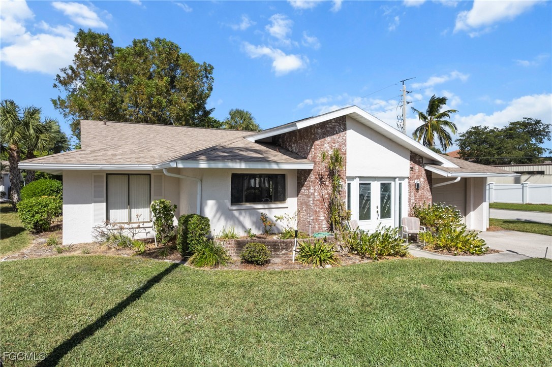 11650 Pointe Circle Fort Myers, FL 33908 - Photo 40 of 40 a front view of a house with a yard and porch