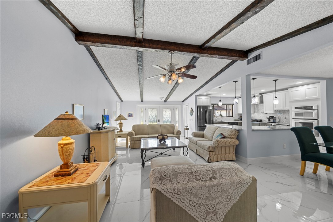 11650 Pointe Circle Fort Myers, FL 33908 - Photo 5 of 40 a living room with furniture and a chandelier