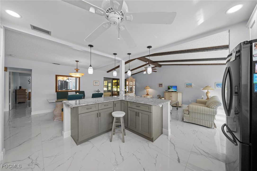 11650 Pointe Circle Fort Myers, FL 33908 - Photo 6 of 40 a kitchen with cabinets and chairs