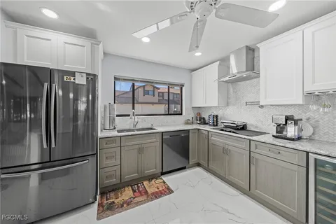 a kitchen with stainless steel appliances a refrigerator sink and cabinets
