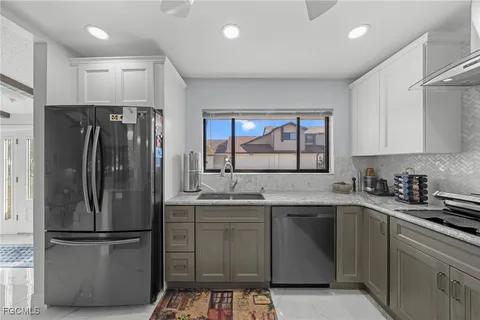 a kitchen with a sink stove and cabinets