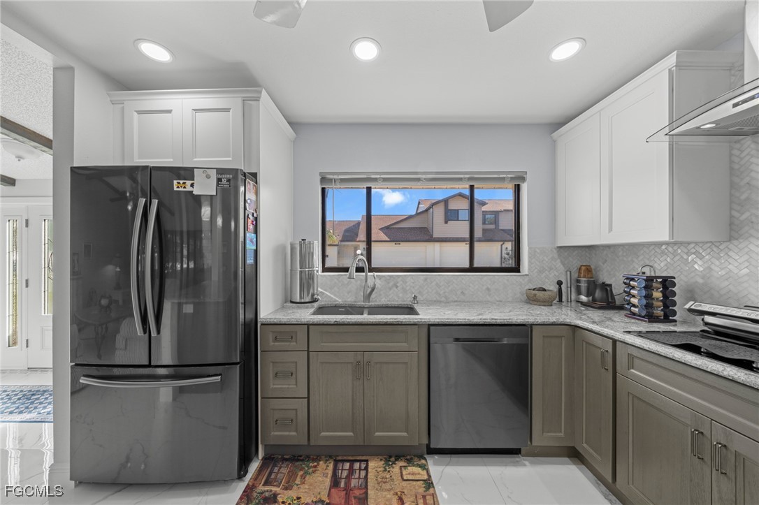 11650 Pointe Circle Fort Myers, FL 33908 - Photo 8 of 40 a kitchen with stainless steel appliances a refrigerator sink and cabinets