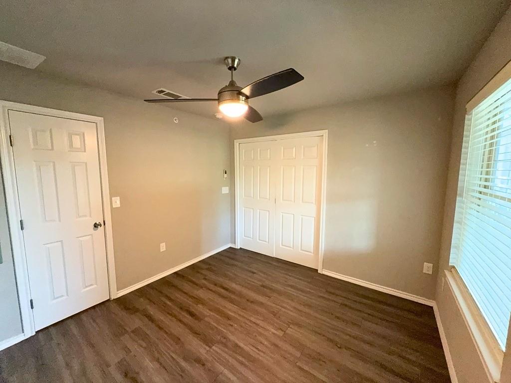 6108 Abrams Road, Unit 222 Dallas, TX 75231 - Photo 11 of 14 a view of empty room with wooden floor and fan