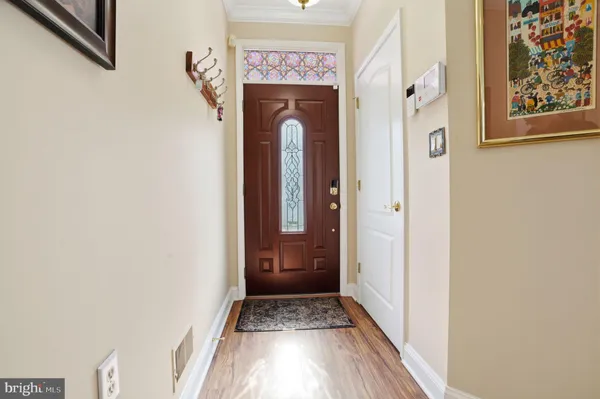 a view of a hallway with wooden floor and entryway