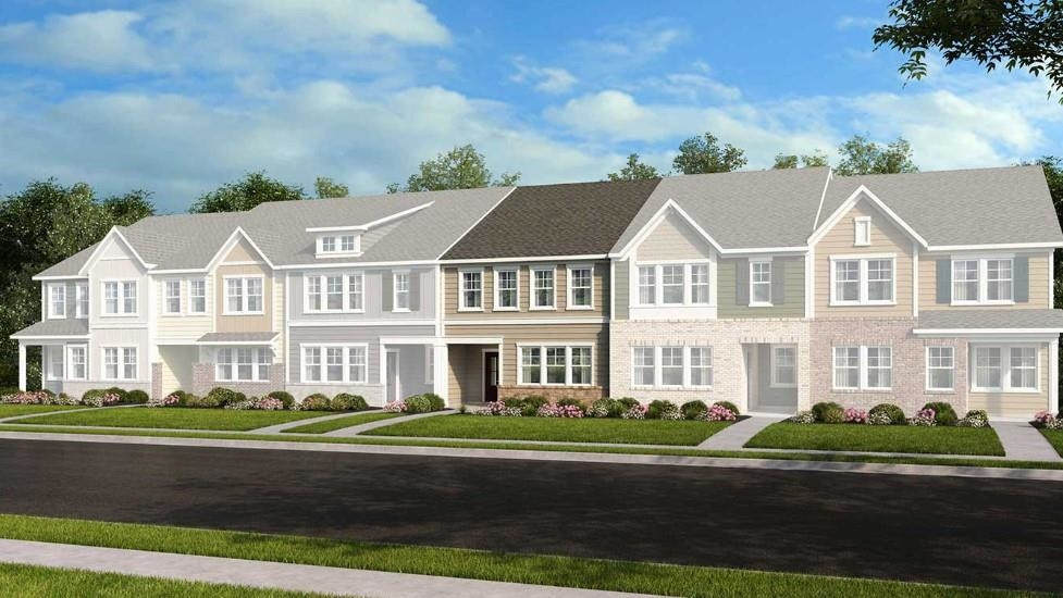 a view of a white house next to a yard