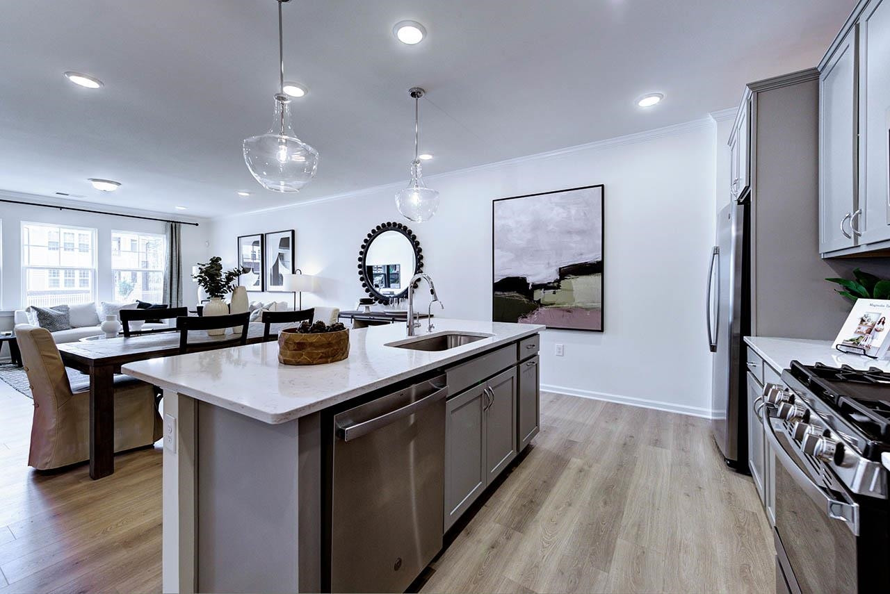 931 Baldwin Rdg Road Apex, NC 27523 - Photo 15 of 42 a kitchen with kitchen island a sink stove and wooden floor