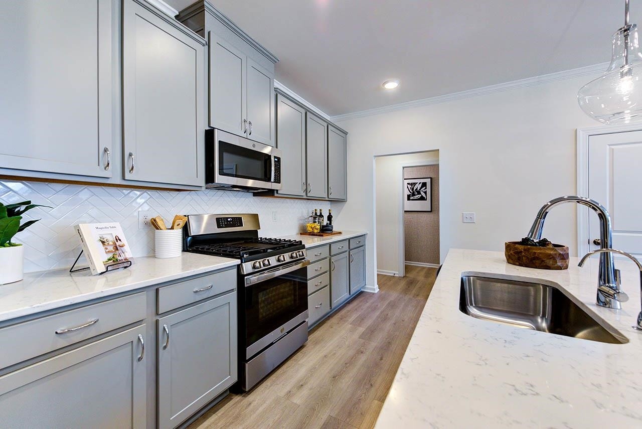 931 Baldwin Rdg Road Apex, NC 27523 - Photo 16 of 42 a kitchen with stainless steel appliances granite countertop a stove a sink and a microwave