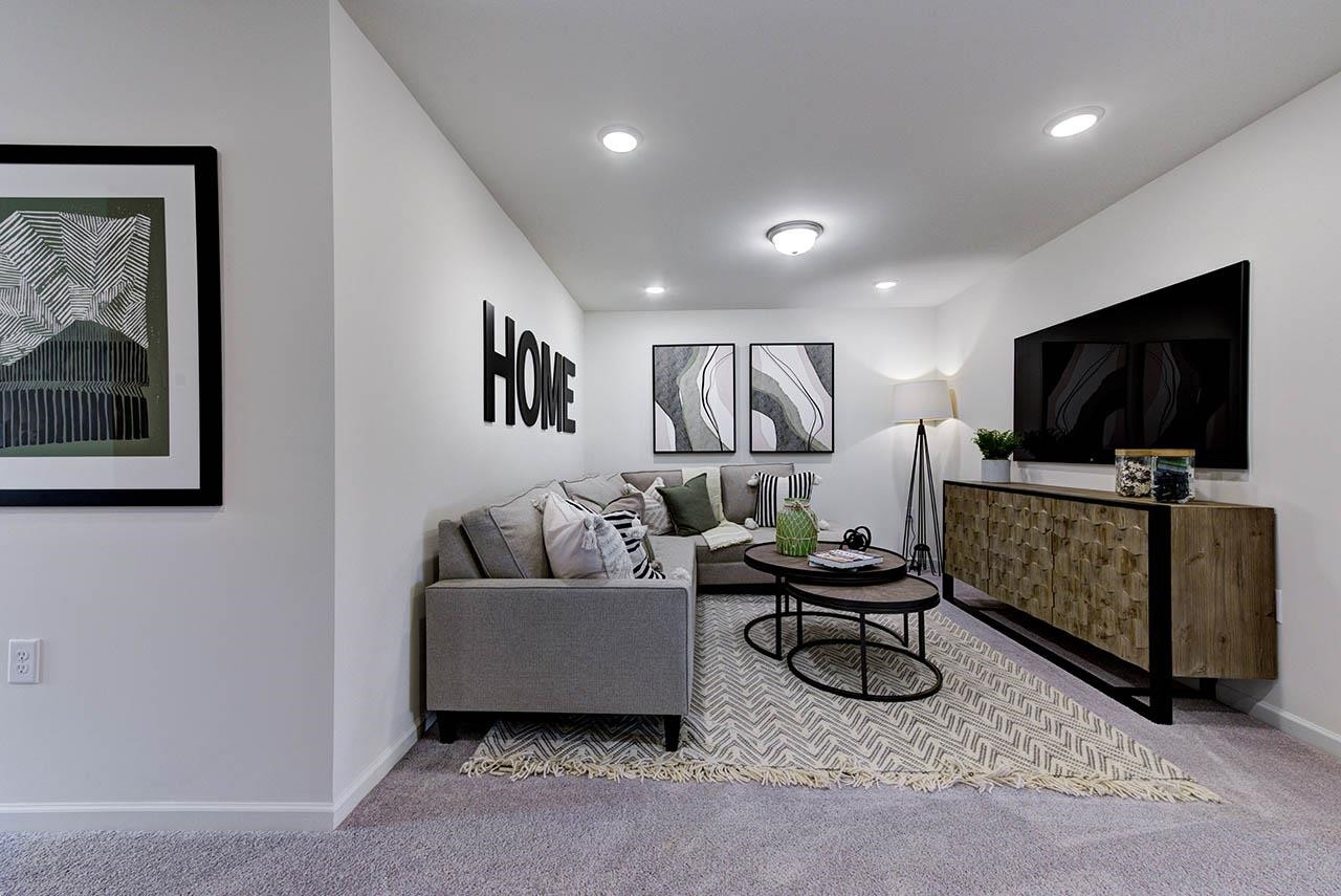 931 Baldwin Rdg Road Apex, NC 27523 - Photo 31 of 42 a living room with furniture and a flat screen tv