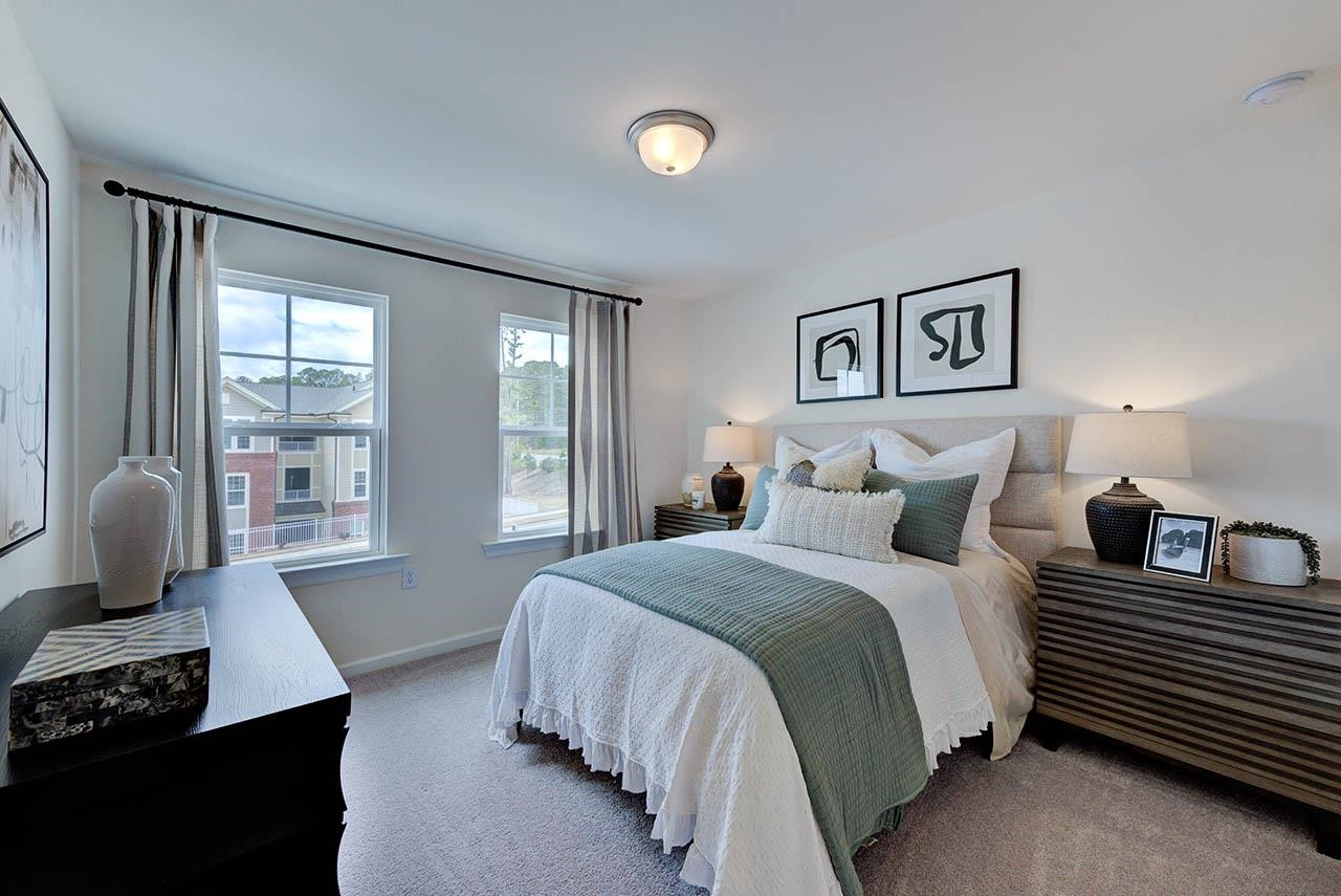 931 Baldwin Rdg Road Apex, NC 27523 - Photo 37 of 42 a bedroom with a bed and wooden floor