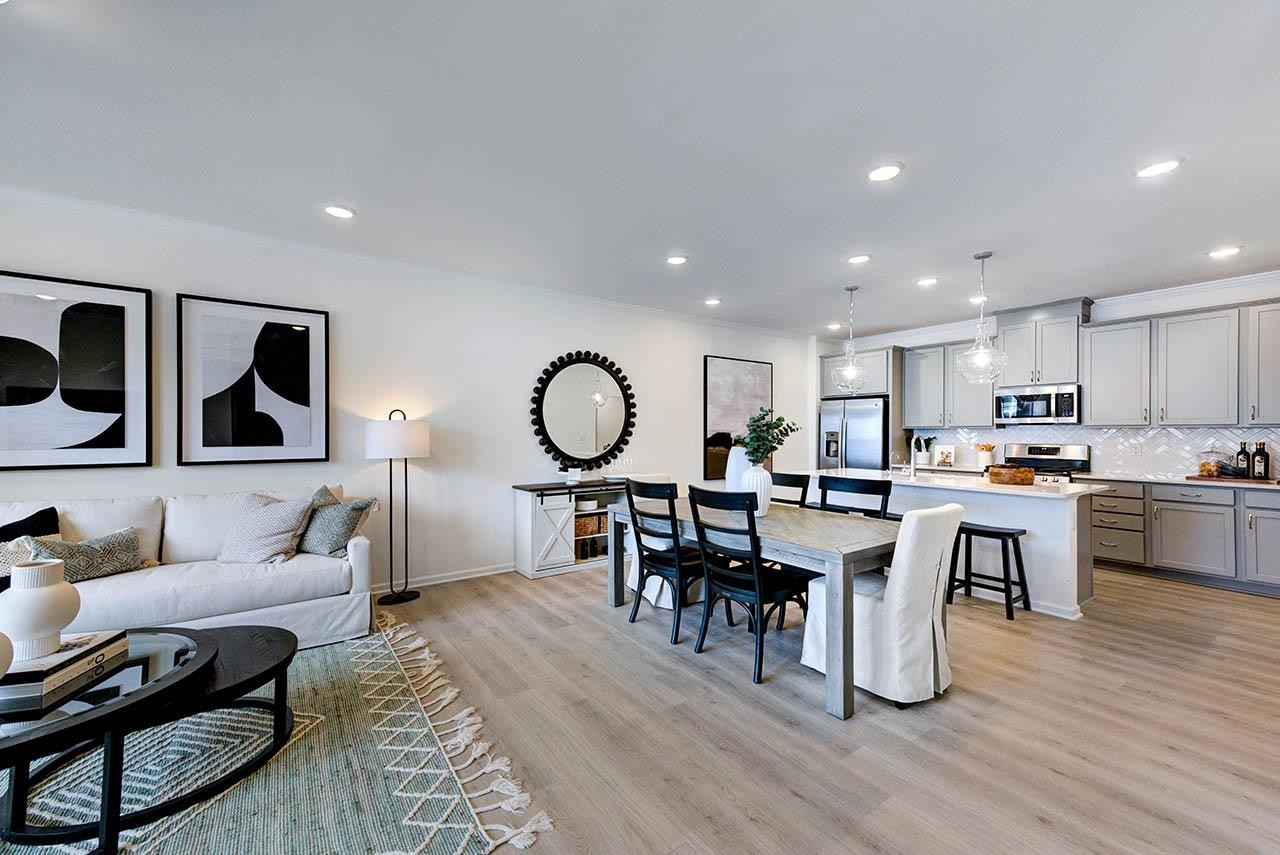 931 Baldwin Rdg Road Apex, NC 27523 - Photo 8 of 42 a living room with furniture kitchen view and a wooden floor