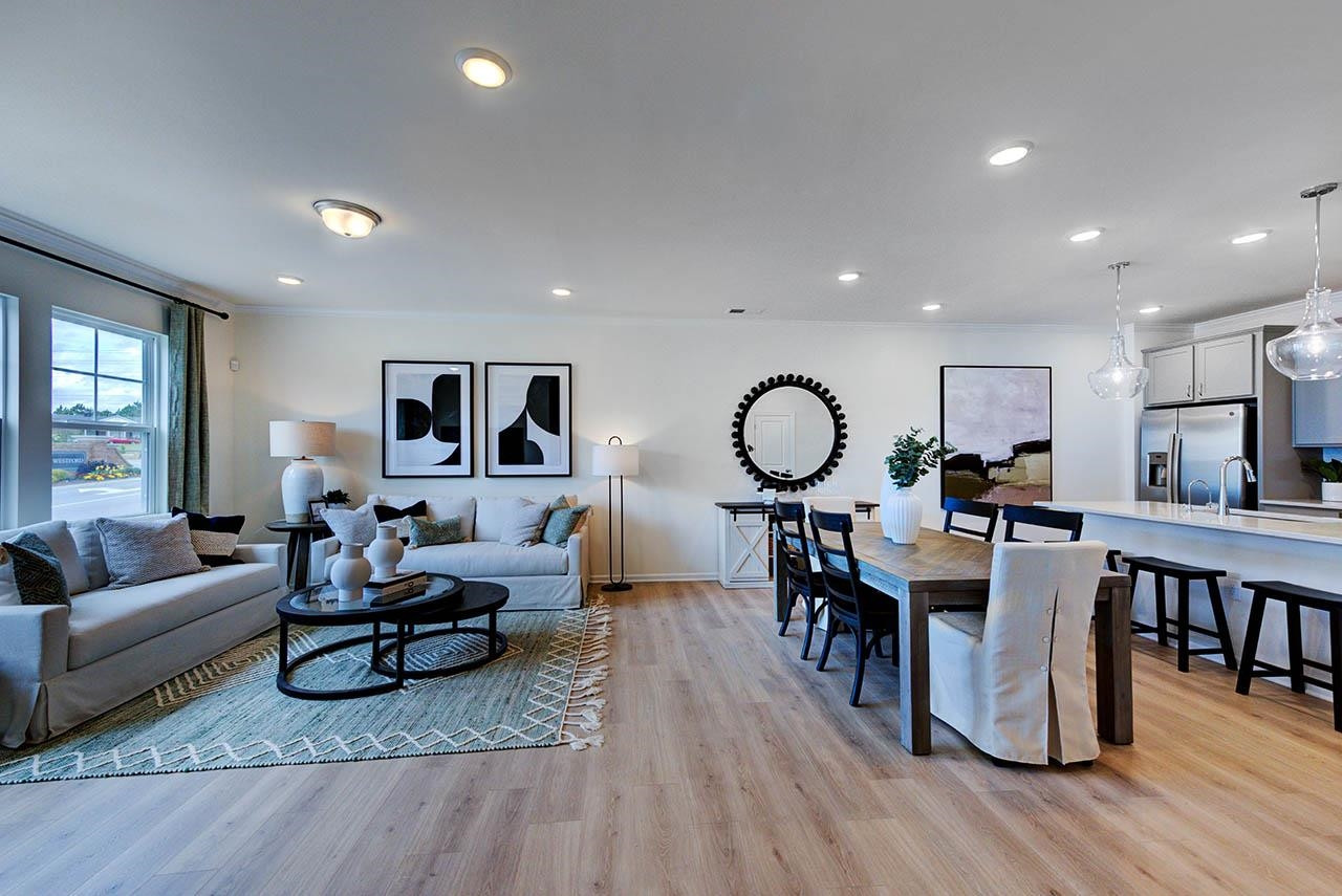 931 Baldwin Rdg Road Apex, NC 27523 - Photo 9 of 42 a living room with furniture a view of dining room and wooden floor