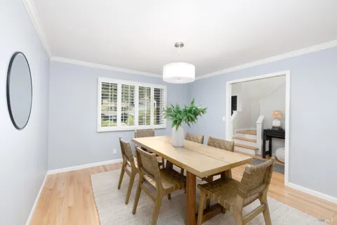 a view of a dining room with furniture and window