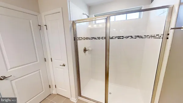 a bathroom with a glass shower door