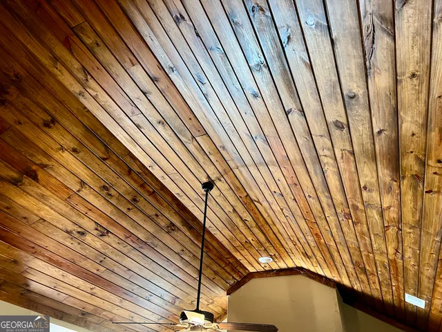 a bedroom with bed and a chandelier