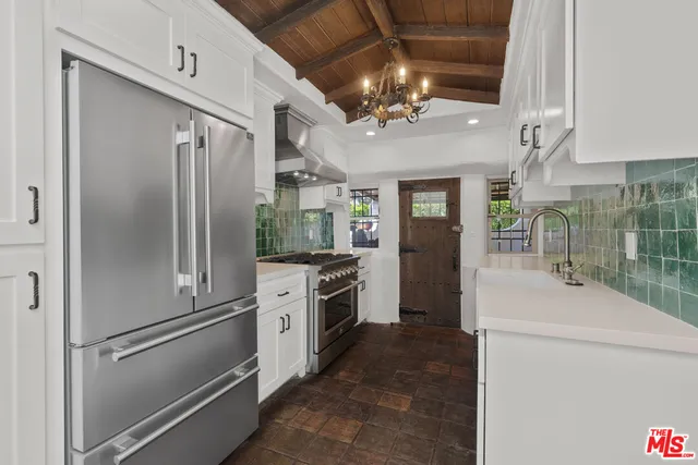 a kitchen with stainless steel appliances a refrigerator sink and cabinets