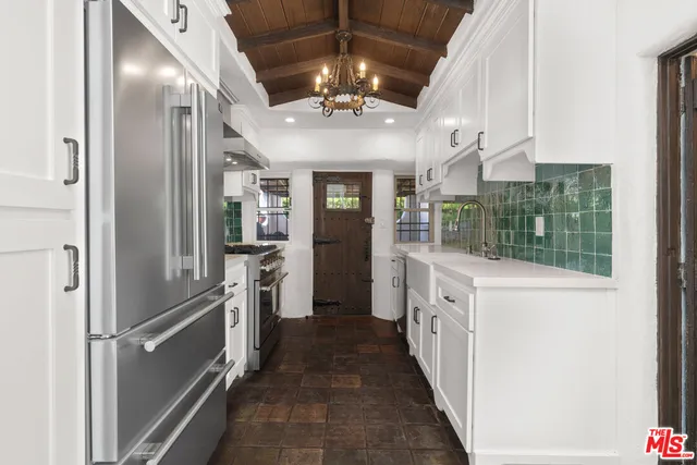 a kitchen with stainless steel appliances a refrigerator and a sink