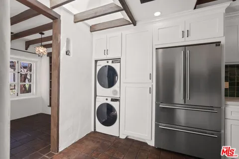 a kitchen with a refrigerator and washer