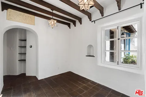 a view of empty room with windows and wardrobe