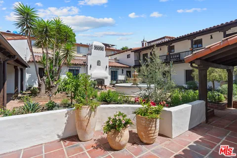 a view of a house with potted plants
