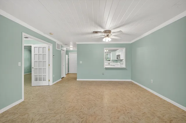 a view of a hallway with closet and bathroom