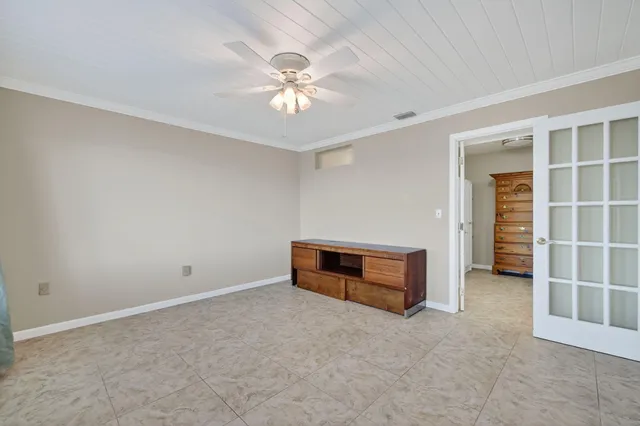 a view of an empty room with large windows