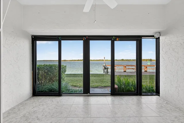 an aerial view of a house with a garden and lake view