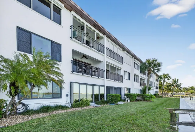 an aerial view of a house with a yard and lake view