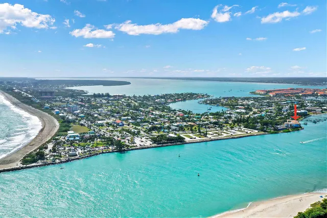 a kitchen with refrigerator cabinets and large window
