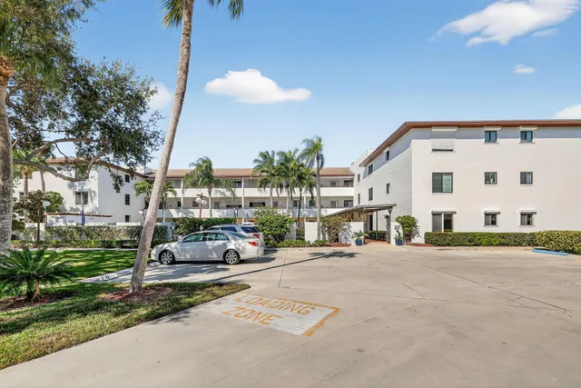 a kitchen with white cabinets appliances and a sink