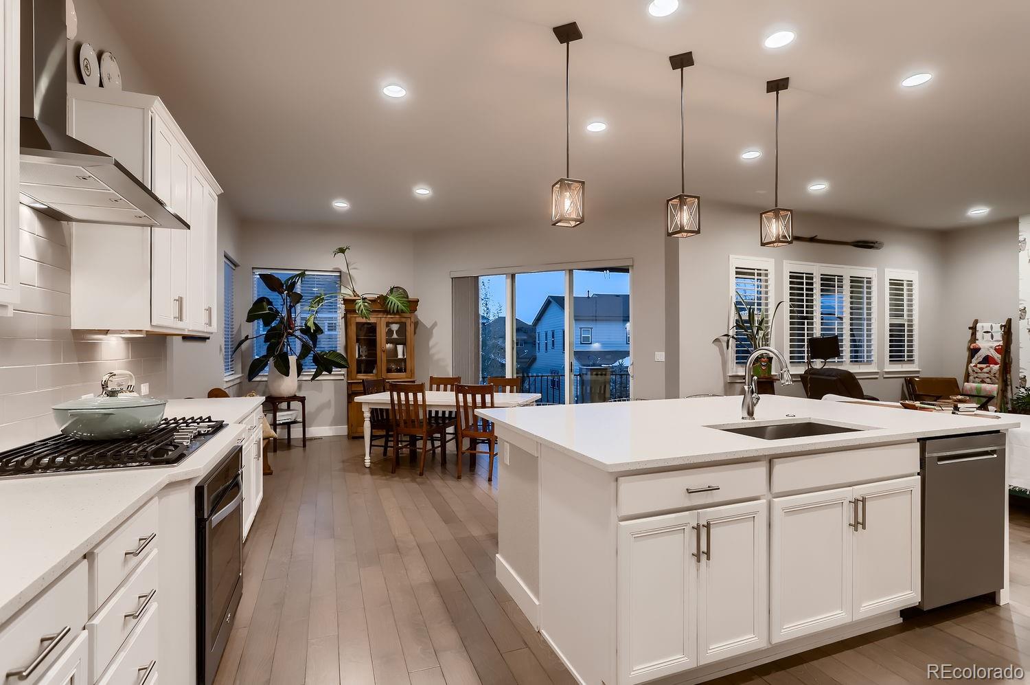 9452 Gore Loop Arvada, CO 80007 - Photo 14 of 30 a kitchen with a sink stainless steel appliances and white cabinets