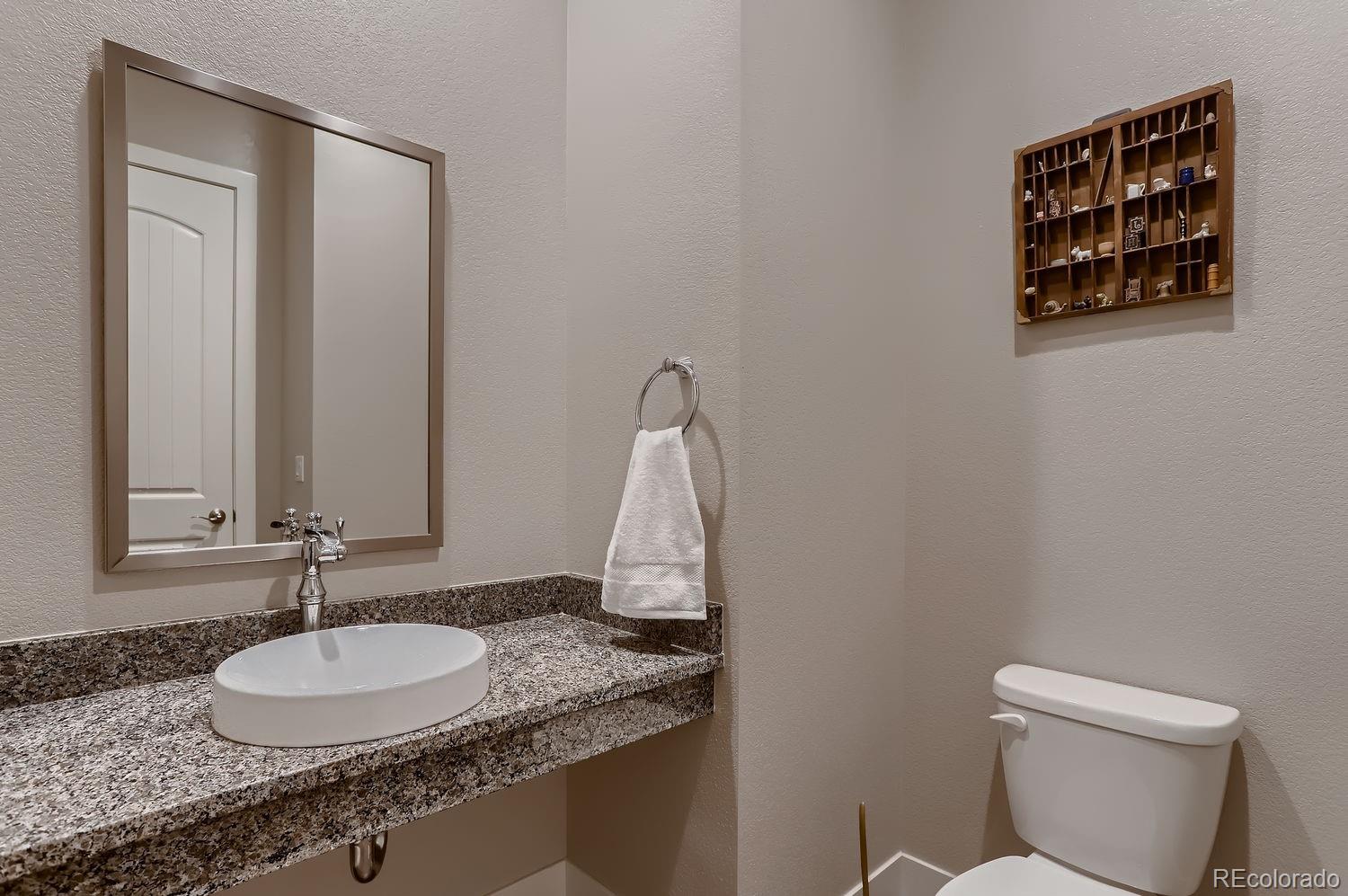 9452 Gore Loop Arvada, CO 80007 - Photo 15 of 30 a bathroom with a granite countertop sink and a mirror