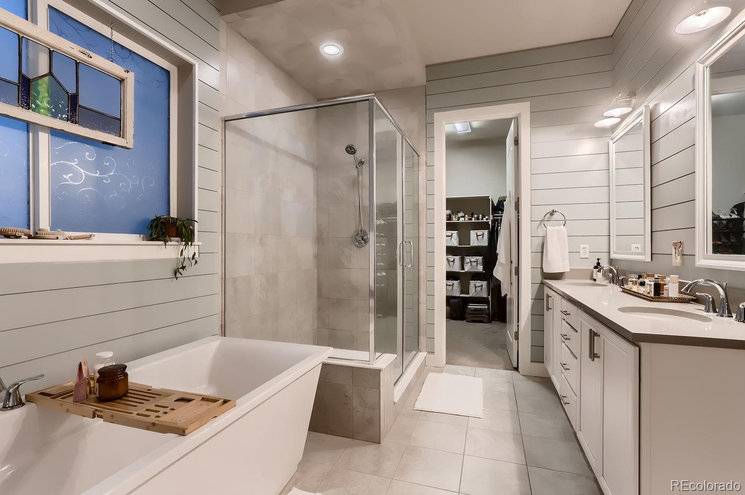 9452 Gore Loop Arvada, CO 80007 - Photo 18 of 30 a bathroom with a tub sink shower and a mirror