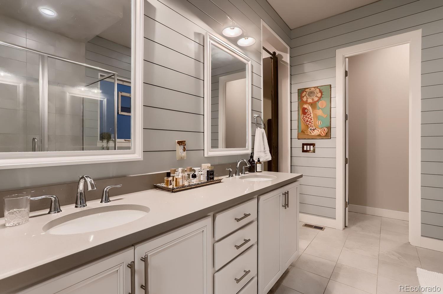 9452 Gore Loop Arvada, CO 80007 - Photo 19 of 30 a bathroom with a double vanity sink and a mirror