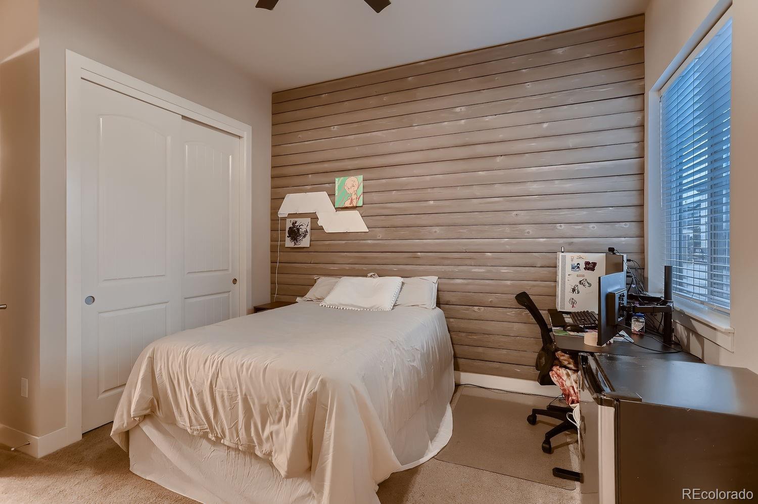 9452 Gore Loop Arvada, CO 80007 - Photo 20 of 30 a bedroom with a bed a desk and chair