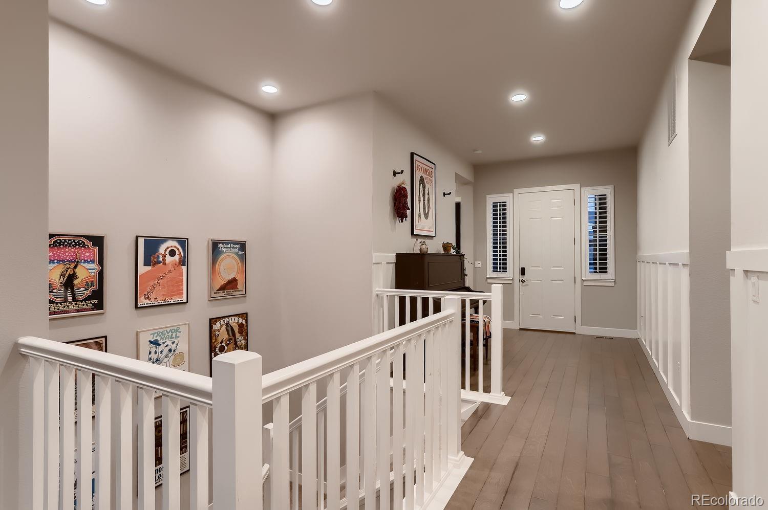9452 Gore Loop Arvada, CO 80007 - Photo 4 of 30 a view of a hallway with workspace and wooden floor