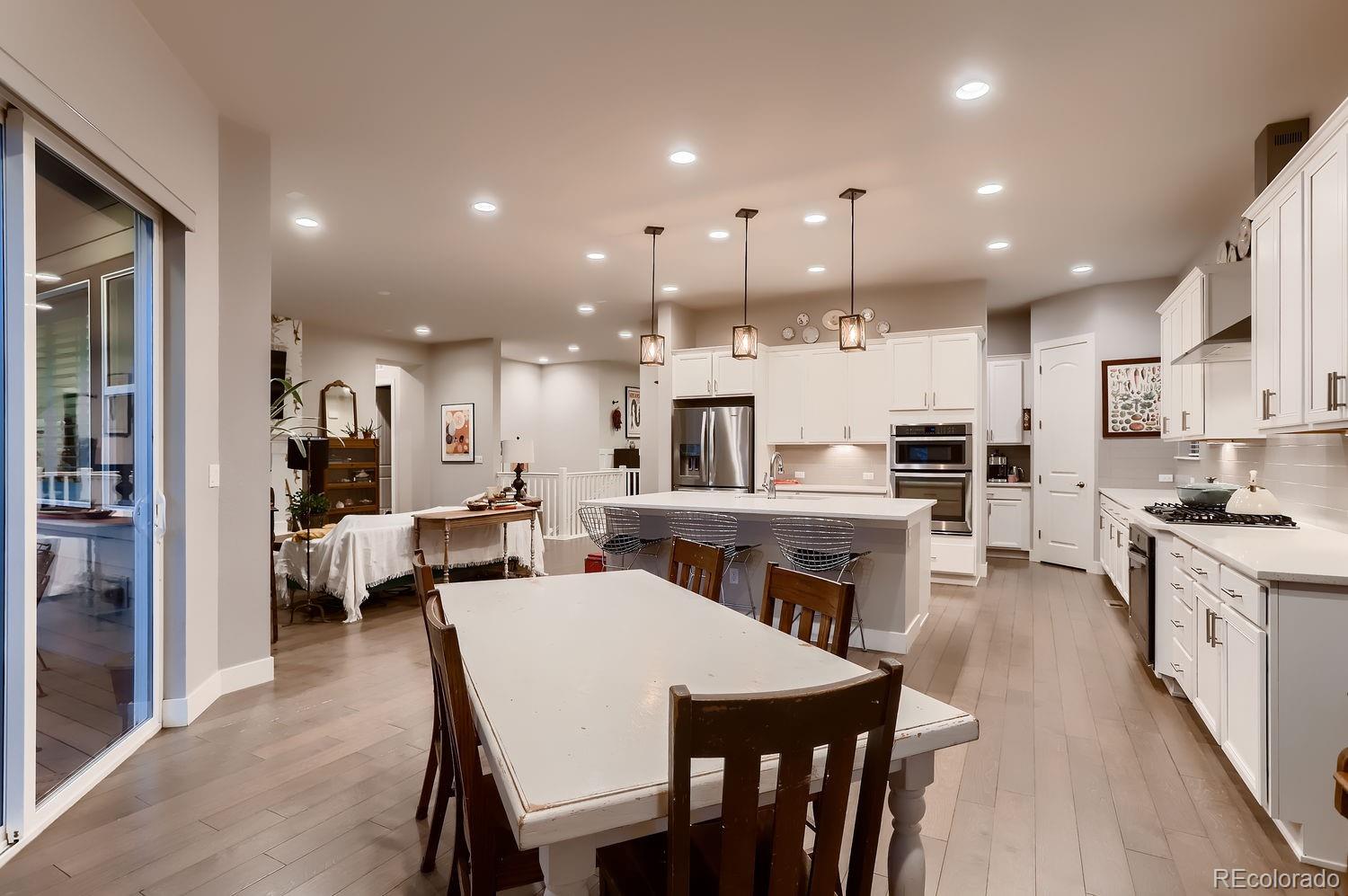 9452 Gore Loop Arvada, CO 80007 - Photo 9 of 30 a large kitchen with a table and chairs