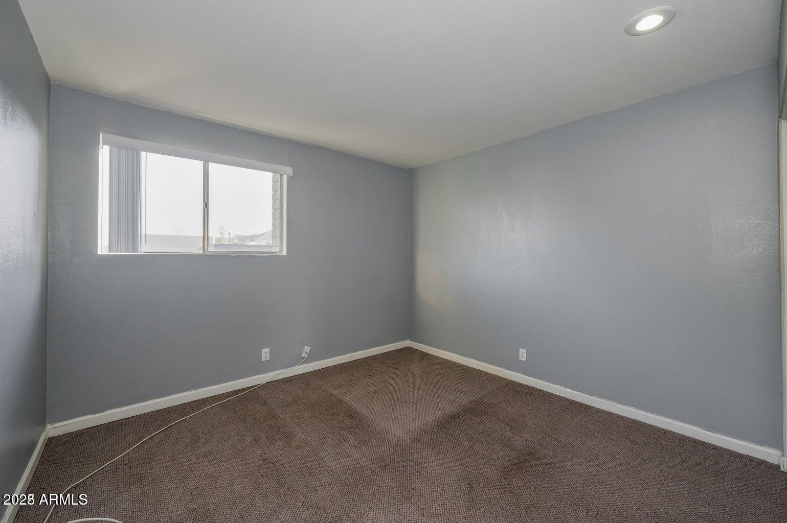 1702 West Tuckey Lane, Unit 212 Phoenix, AZ 85015 - Photo 18 of 20 an empty room with a window