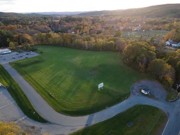 an aerial view of a house with yard