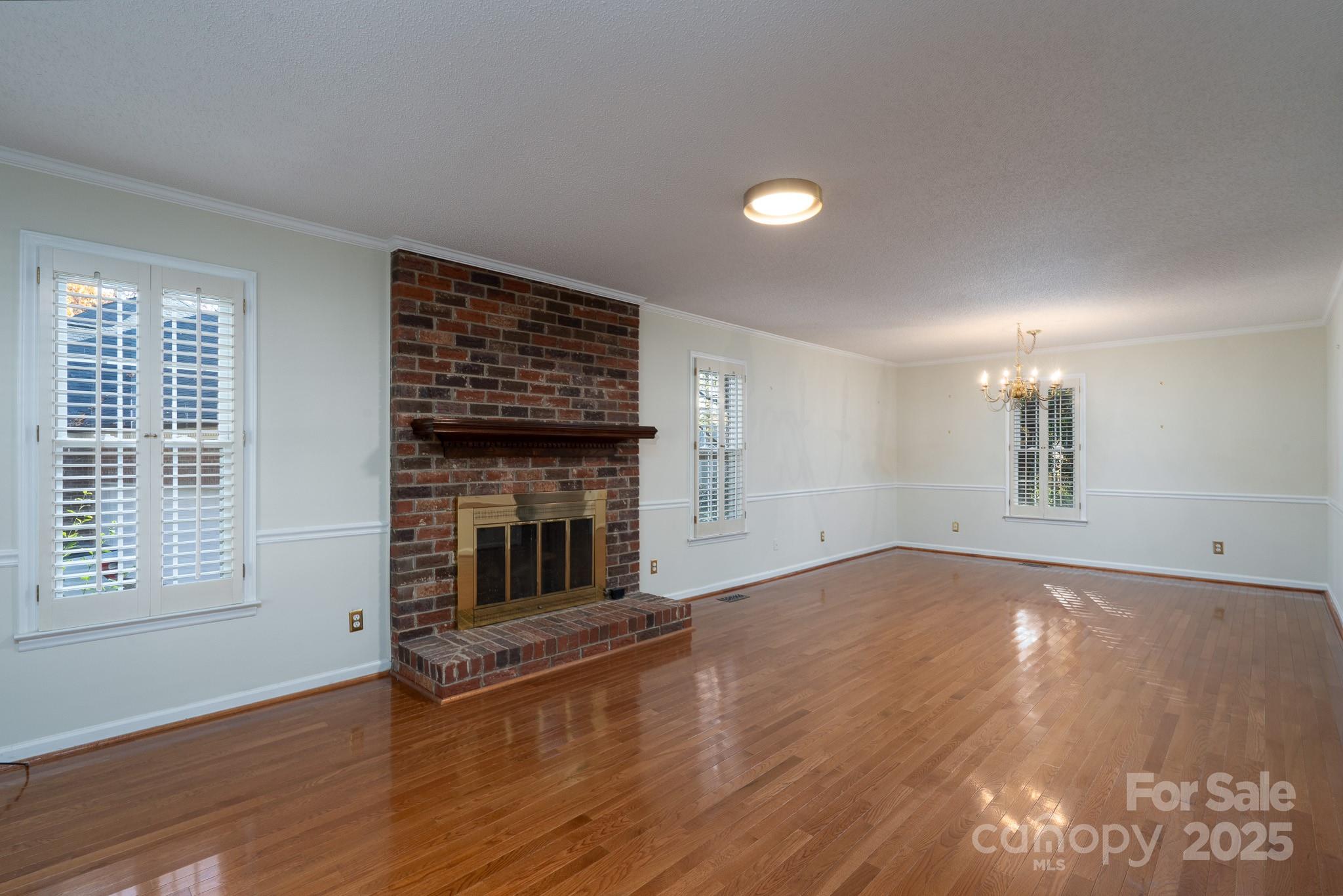 621 Peacehaven Road Kannapolis, NC 28083 - Photo 19 of 44 a view of empty room with wooden floor and fireplace
