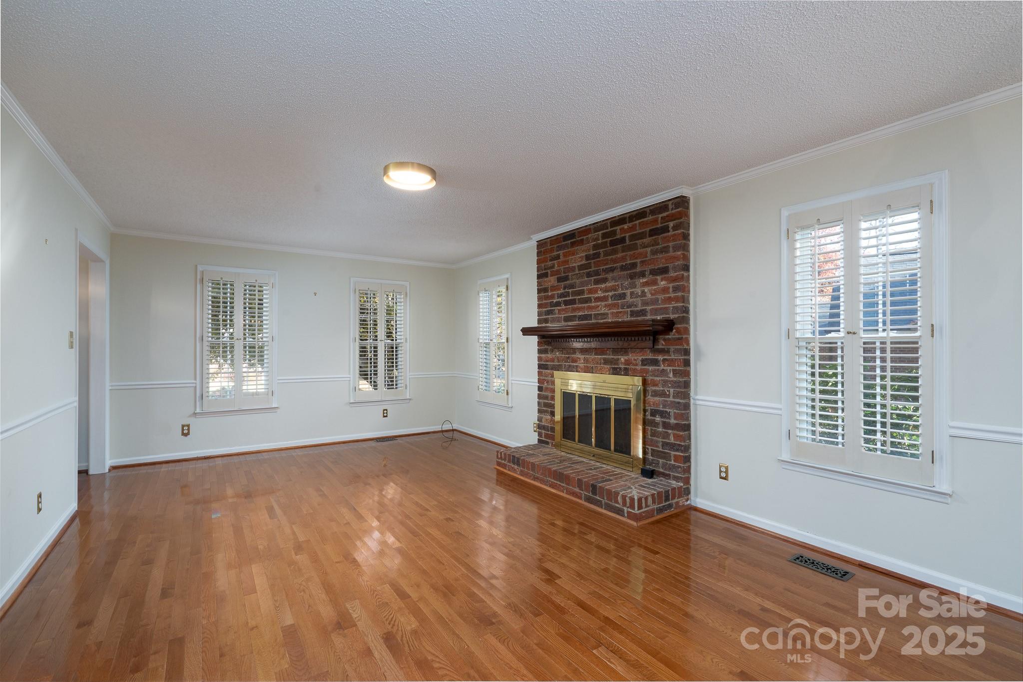621 Peacehaven Road Kannapolis, NC 28083 - Photo 20 of 44 a view of empty room with wooden floor and fireplace