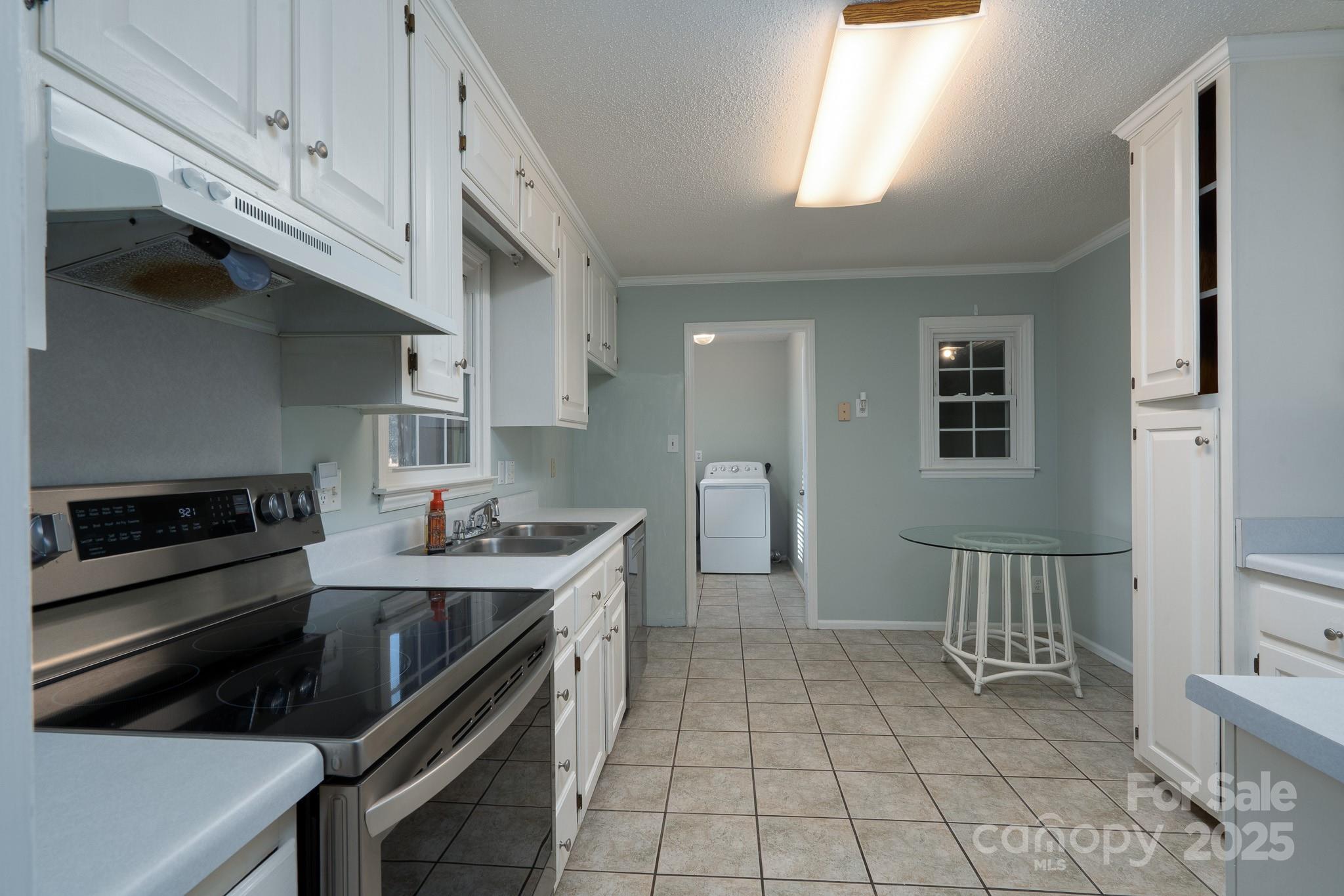 621 Peacehaven Road Kannapolis, NC 28083 - Photo 26 of 44 a kitchen with a sink a stove and cabinets
