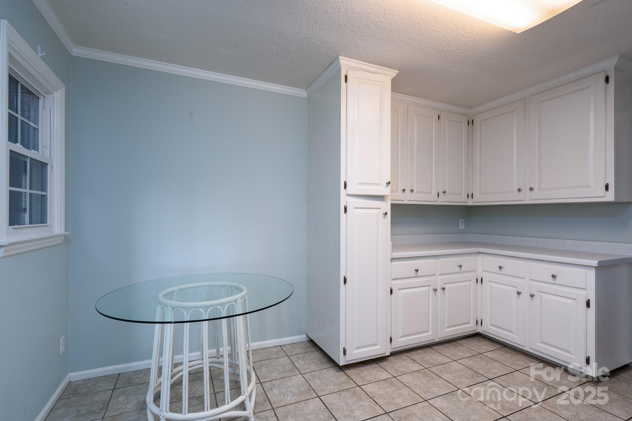 621 Peacehaven Road Kannapolis, NC 28083 - Photo 28 of 44 a kitchen with white cabinets and a sink