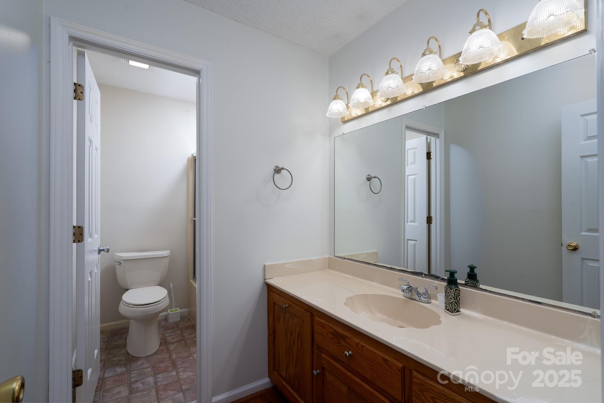 621 Peacehaven Road Kannapolis, NC 28083 - Photo 30 of 44 a bathroom with a sink a toilet and a large mirror