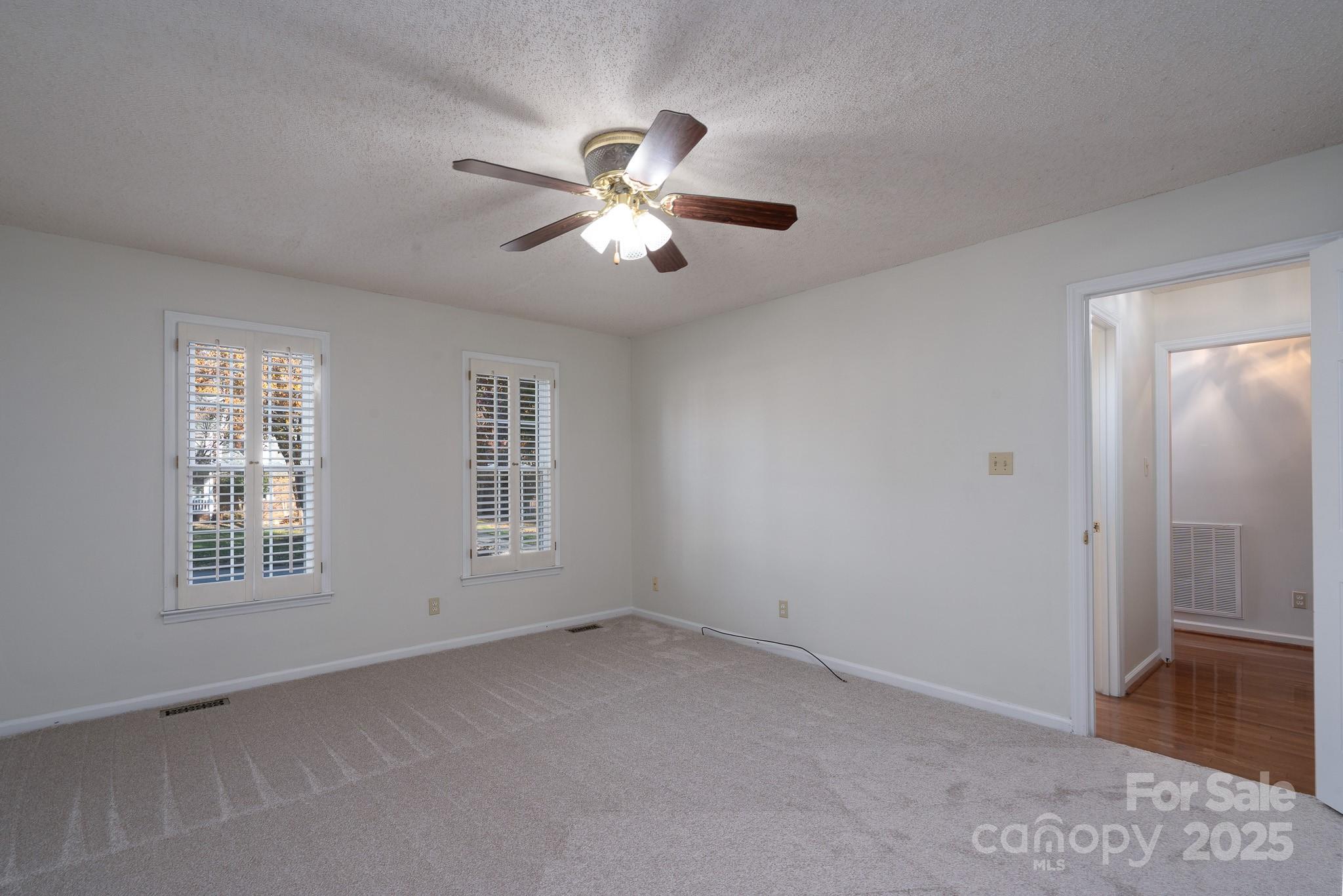 621 Peacehaven Road Kannapolis, NC 28083 - Photo 32 of 44 a view of empty room with wooden floor and fan