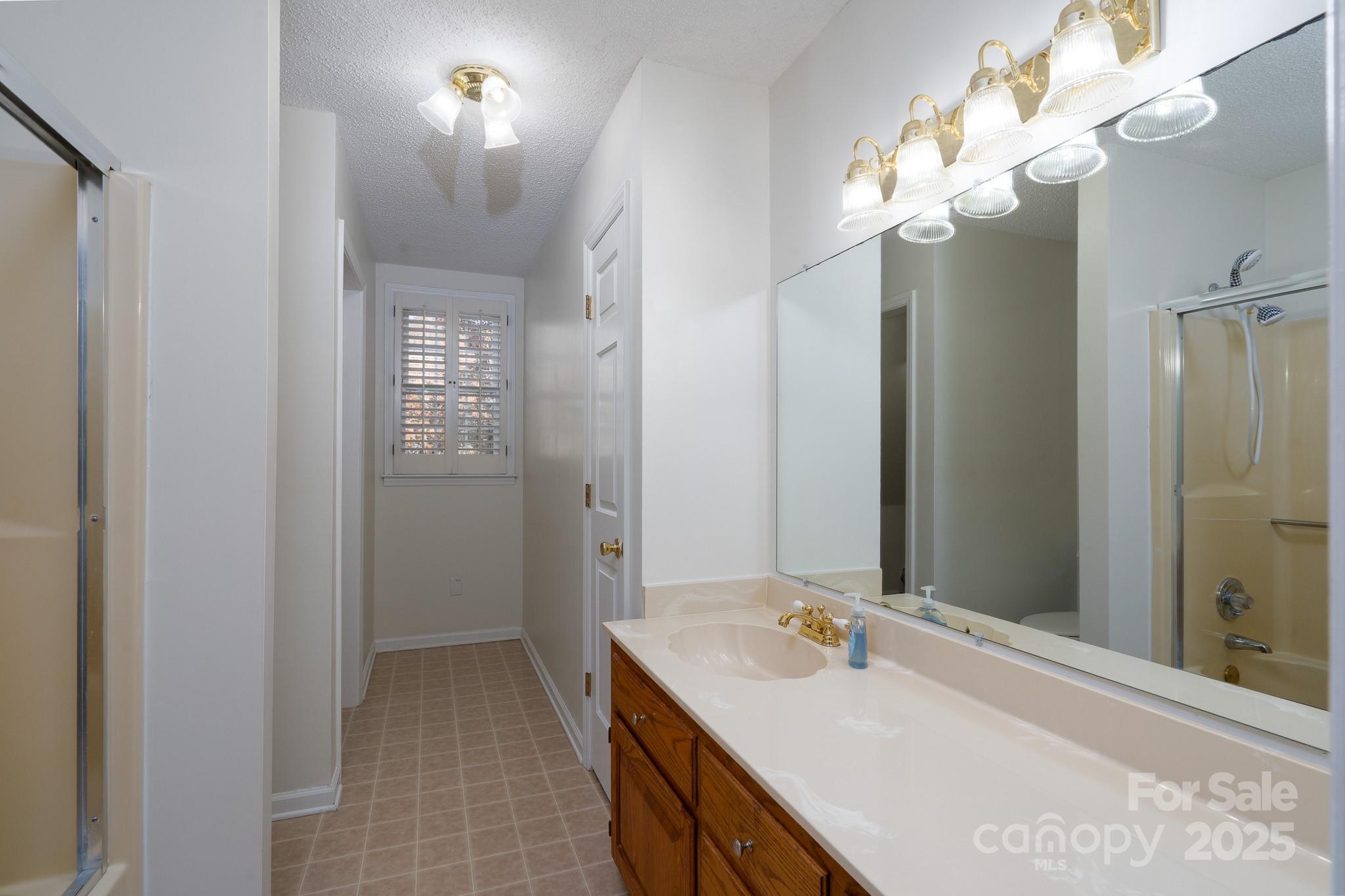 621 Peacehaven Road Kannapolis, NC 28083 - Photo 43 of 44 a bathroom with a sink vanity and a mirror
