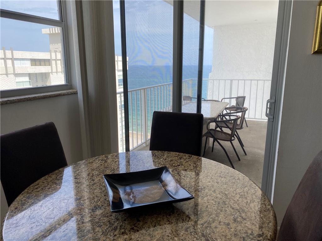 1010 South Ocean Boulevard, Unit PH12 Pompano Beach, FL 33062 - Photo 12 of 47 a living room with furniture rug and a window